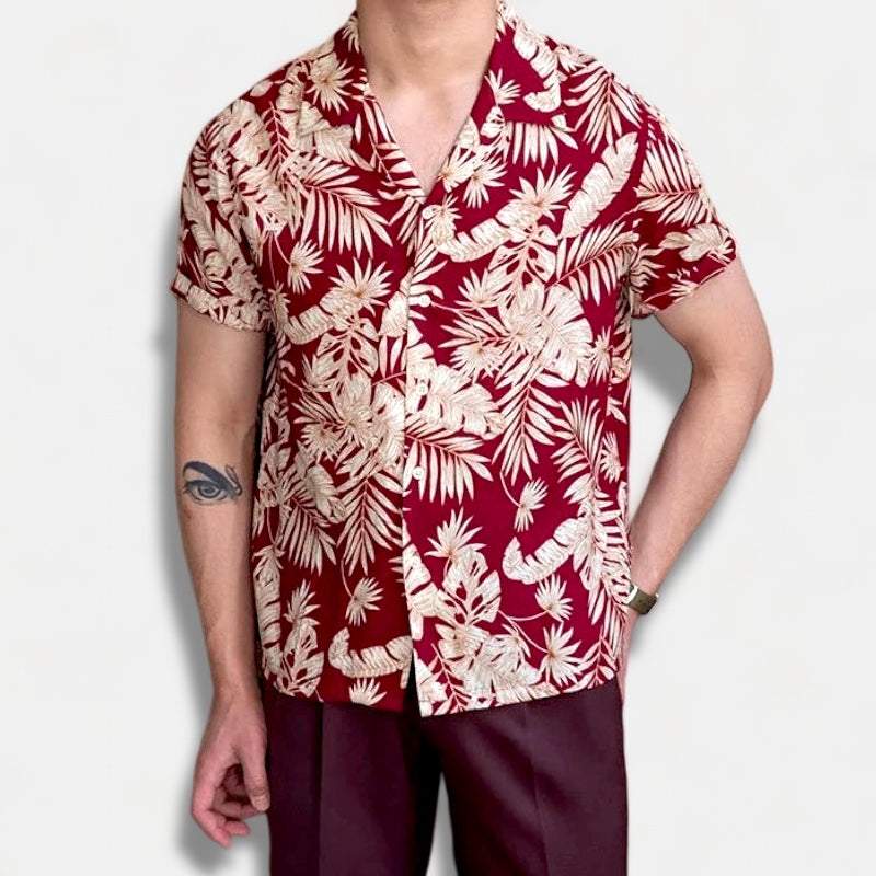 Man wearing a red vintage Hawaiian flower shirt.