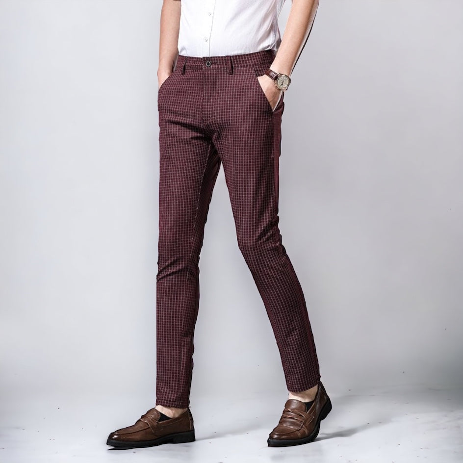 Man wearing Vinny Plaid Trousers in wine red, styled with white shirt and brown shoes.