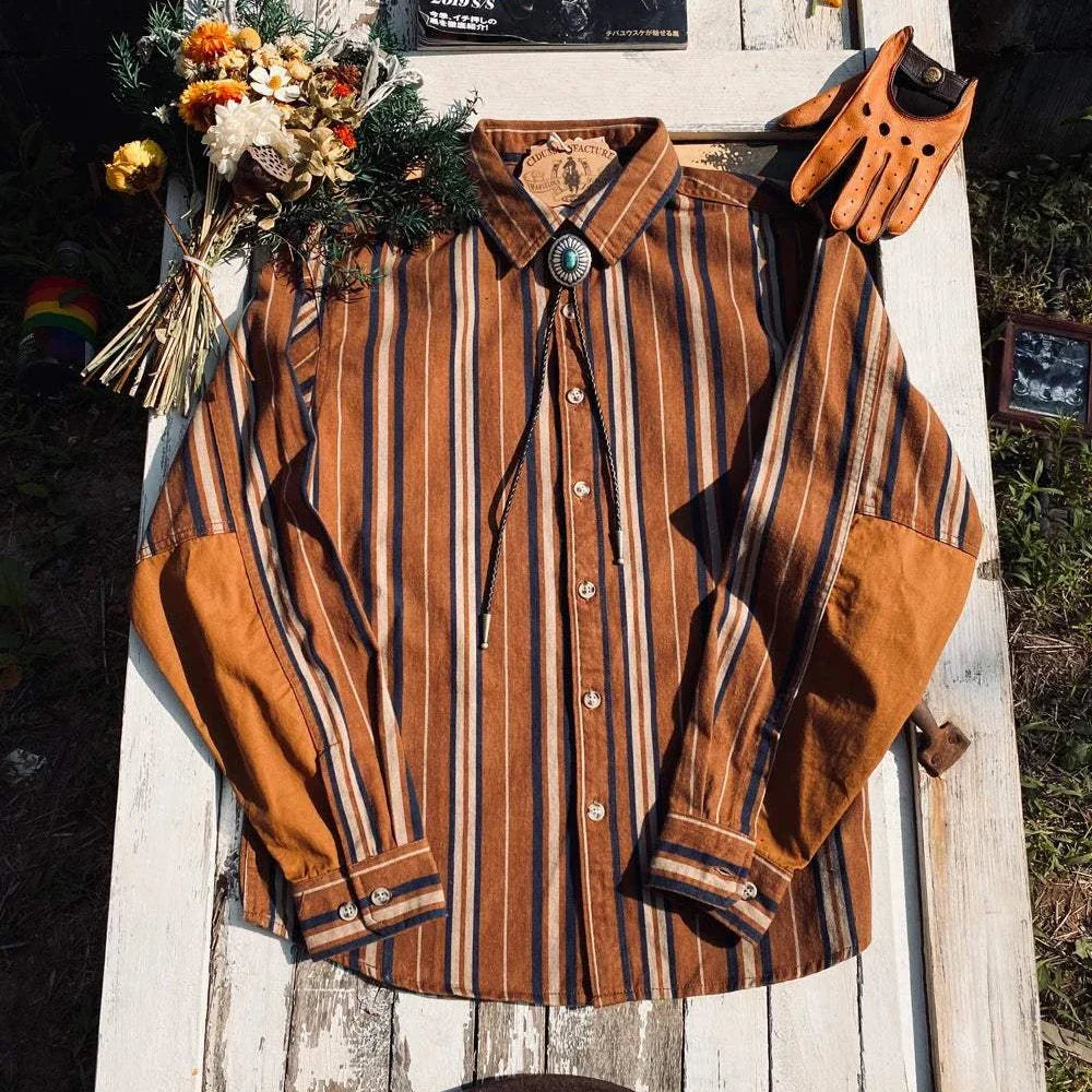 Vintage summer cotton shirt with stripes, classic collar, on outdoor table with flowers and accessories.