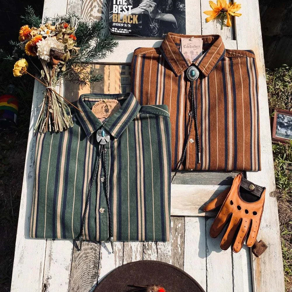 Vintage summer cotton shirts with stripes displayed on a rustic wooden table, styled with accessories.