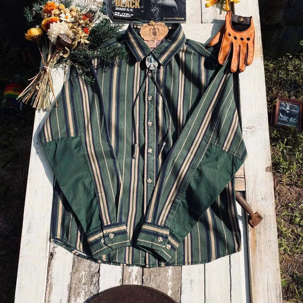 Vintage summer cotton shirt with stripes, classic collar, laid on outdoor surface with flowers and accessories.