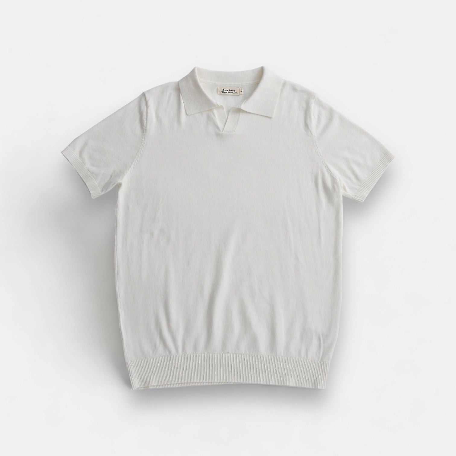 Old money American polo t-shirt in solid white, casual elegant style, comfortable cotton for spring/summer.