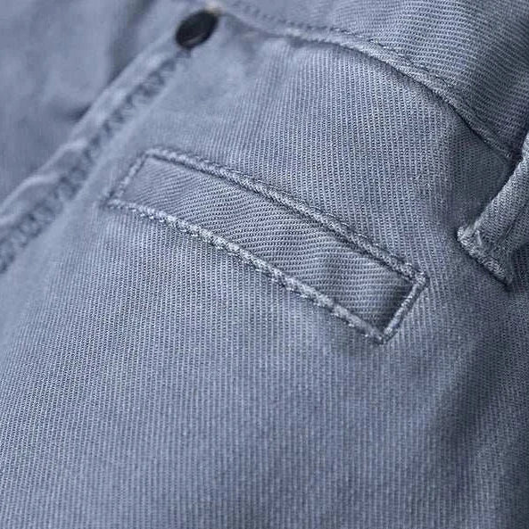 Close-up of cotton straight chino pants with pocket detail.