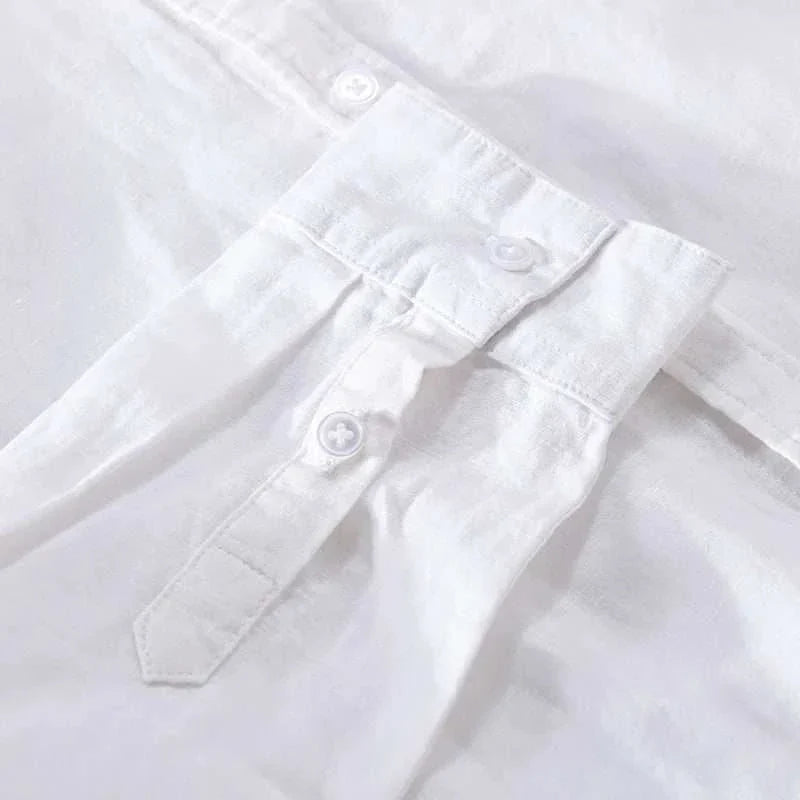 Summer casual long-sleeve shirt in white, close-up of fabric and button details.