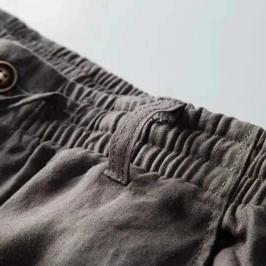 Italian design linen pants with elastic waistband and button detail.