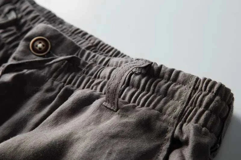 Italian design linen pants with elastic waistband and button detail.