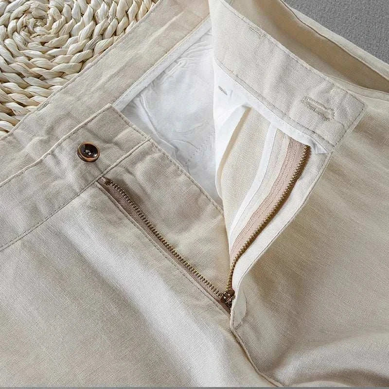 Linen casual pants with zipper and button detail, made from breathable fabric.