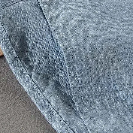 Close-up of blue linen casual pants showing texture and stitching.