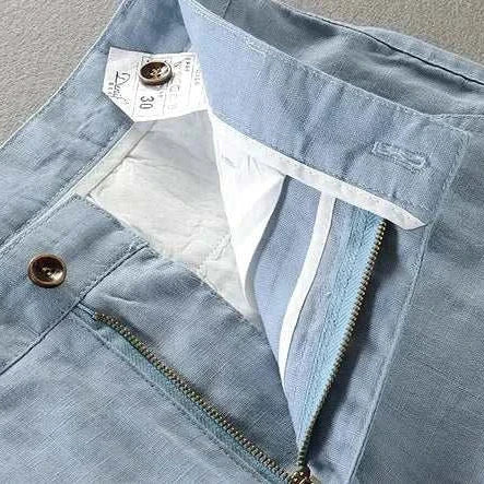 Blue linen casual pants with zipper and button detail.