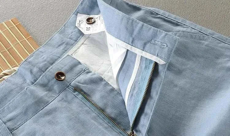 Blue linen casual pants with zipper and button detail.