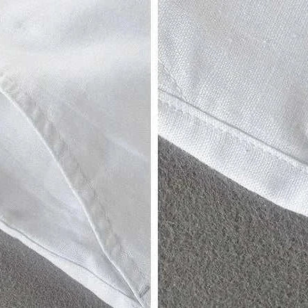 Close-up view of white linen casual pants fabric texture and stitching detail.