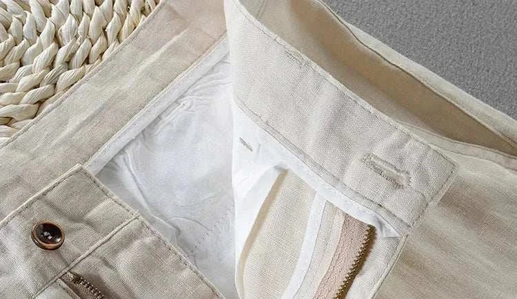 Close-up view of linen casual pants highlighting the button and zipper details.