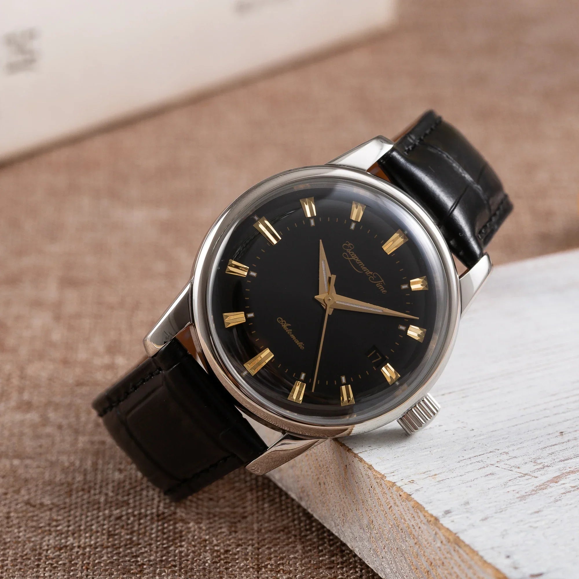 Stainless steel automatic vintage watch with black dial and leather strap, ideal for business style.