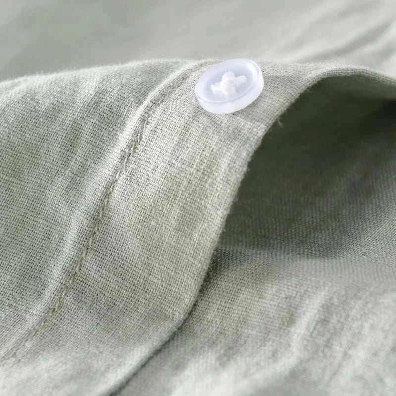 Close-up of a linen-cotton summer casual long-sleeve shirt button.