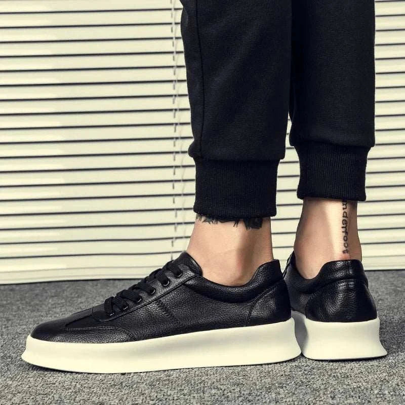Student leather casual shoes in black leather with white sole, worn with casual pants.