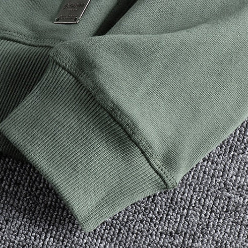 Maurice Cardigan sleeve detail on textured fabric background.