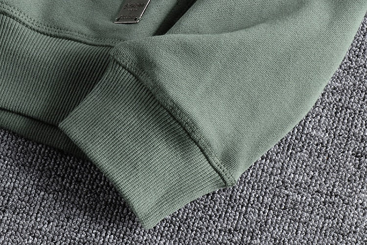 Maurice Cardigan sleeve detail on textured fabric background.