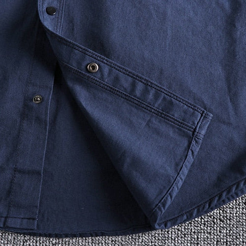 Close-up of Vintage-Retro Cotton Shirt fabric in blue showing button details and stitching.