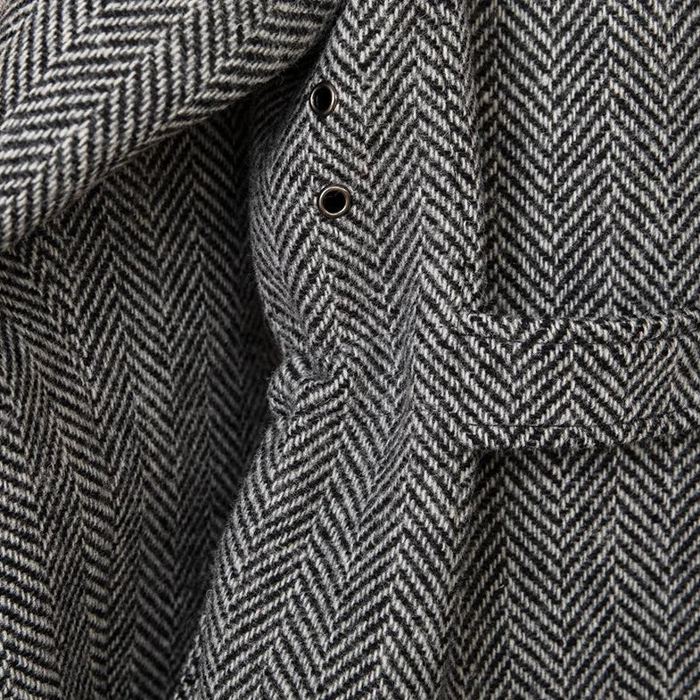 Close-up of a wool heavy vintage coat in herringbone pattern.