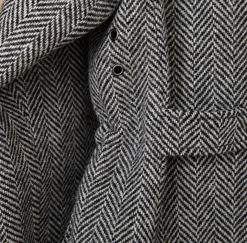 Close-up of a wool heavy vintage coat in herringbone pattern.