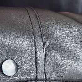 Close-up of MOTO black leather jacket sleeve detailing.