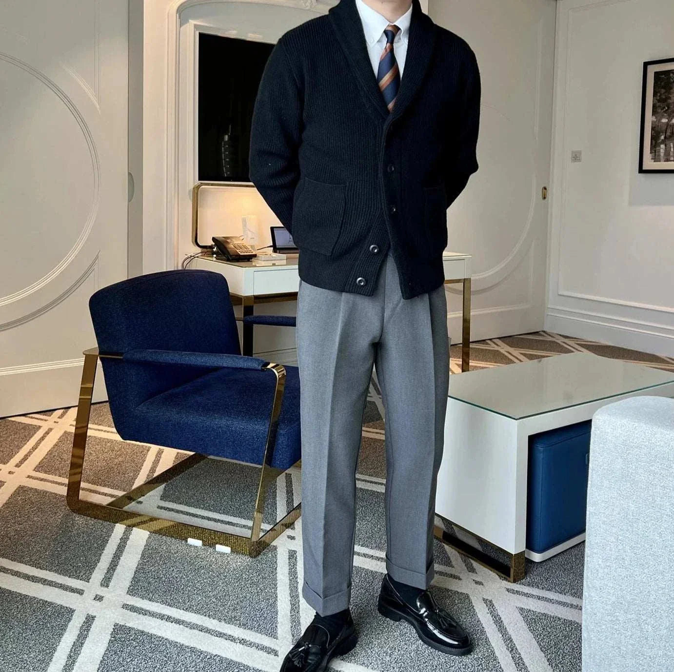 Fall season casual cardigan in black worn by a man in a stylish office setting.