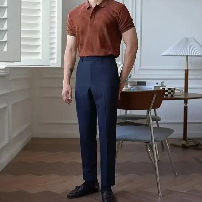 LUXELY vintage t-shirt in striped design, paired with high-waisted trousers, in a stylish indoor setting.