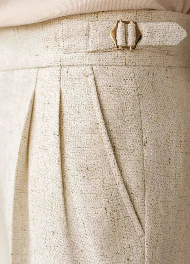 Paris high-waist design trousers in textured fabric with elegant pleats and buckle detail.