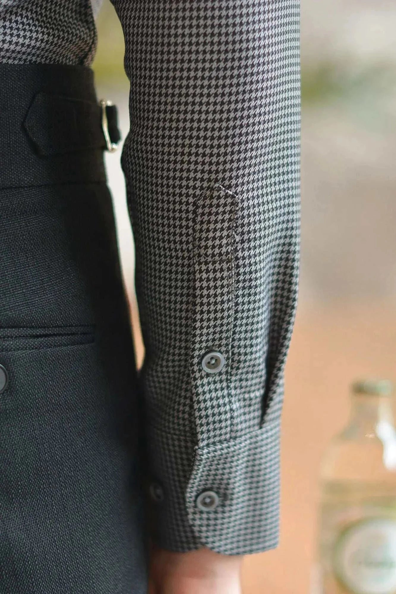 Office tuxedo long-sleeve shirt close-up with elegant button details.