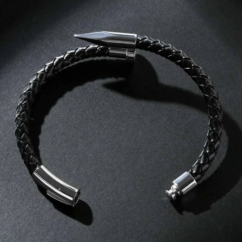 Nail leather men bracelet with stainless steel detailing on dark background.