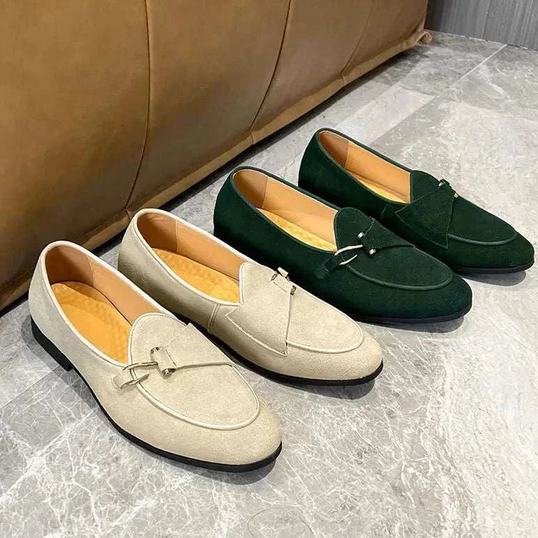 Elegant suede leather loafers in beige and green on display floor.