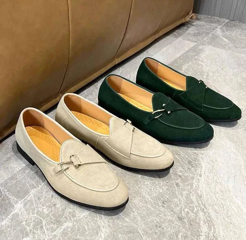 Elegant suede leather loafers in beige and green on display floor.