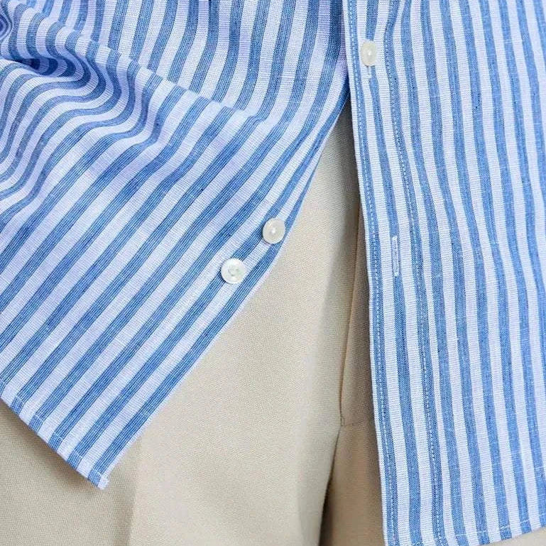 Striped long-sleeve shirt with white buttons made from linen and cotton.