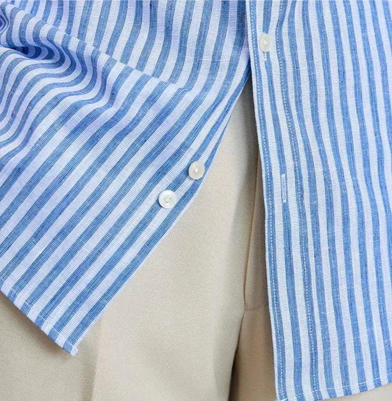 Striped long-sleeve shirt with white buttons made from linen and cotton.