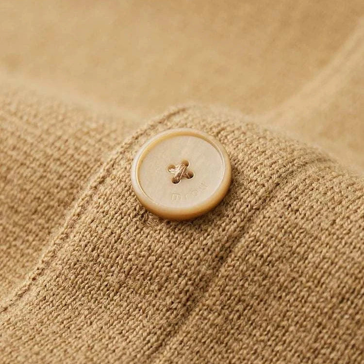 Close-up of Antonios wool polo collar cardigan button detail.