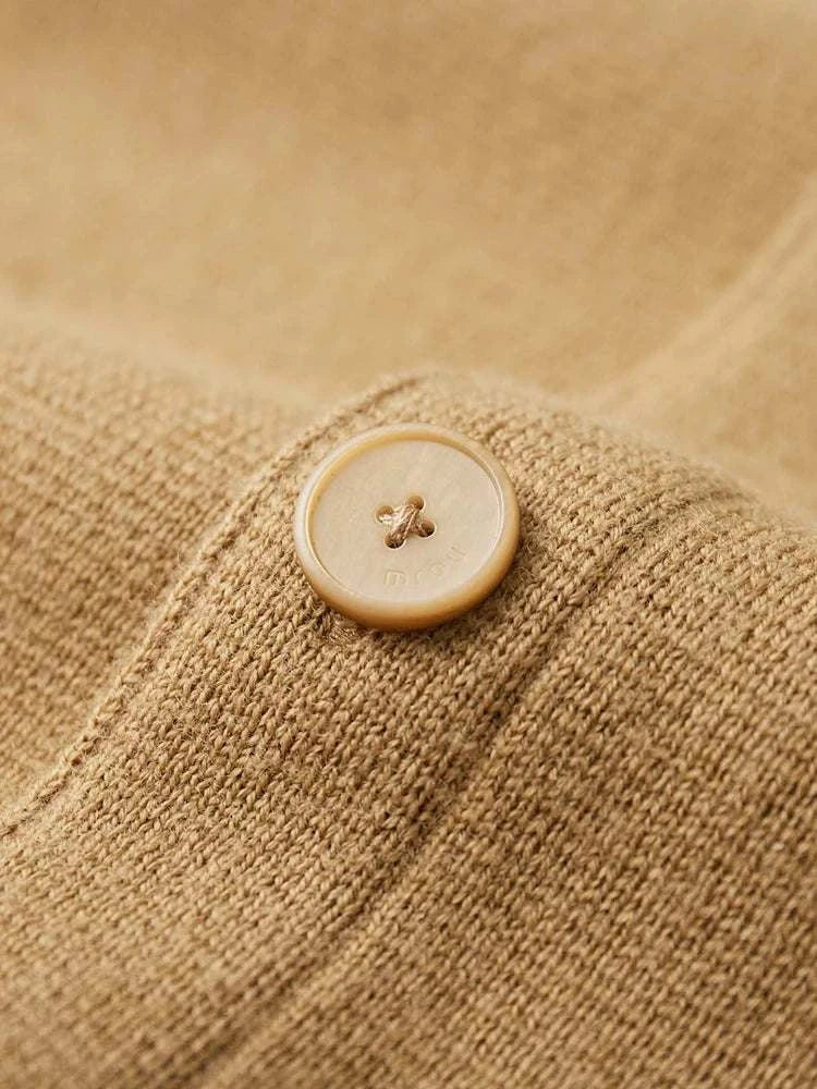 Close-up of Antonios wool polo collar cardigan button detail.