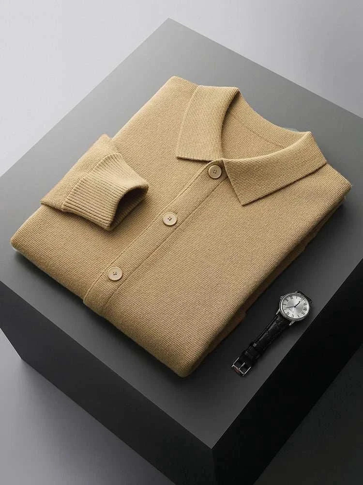 Antonios wool polo collar cardigan folded on a table next to a watch.