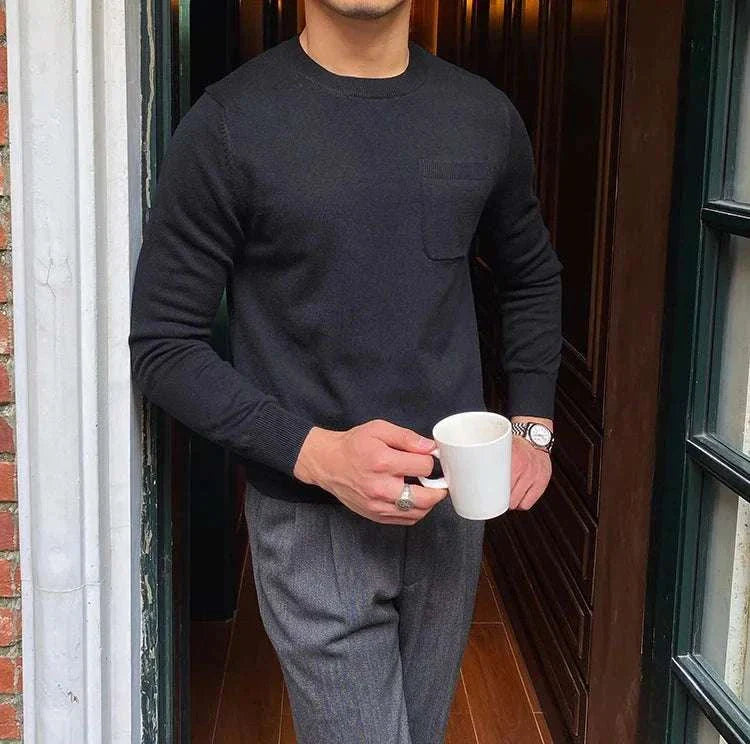 Man wearing Antonios office premium sweater holding a coffee mug.