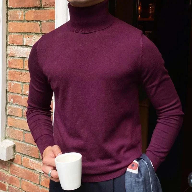 Man wearing a burgundy Antonios business turtleneck sweater holding a coffee mug.