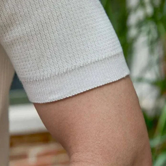 Close-up of short sleeves on a white summer v-neck polo English t-shirt.