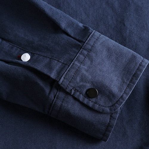 Close-up of a navy blue Vintage-Retro Cotton Shirt sleeve with button detail.