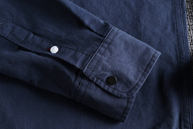 Close-up of a navy blue Vintage-Retro Cotton Shirt sleeve with button detail.