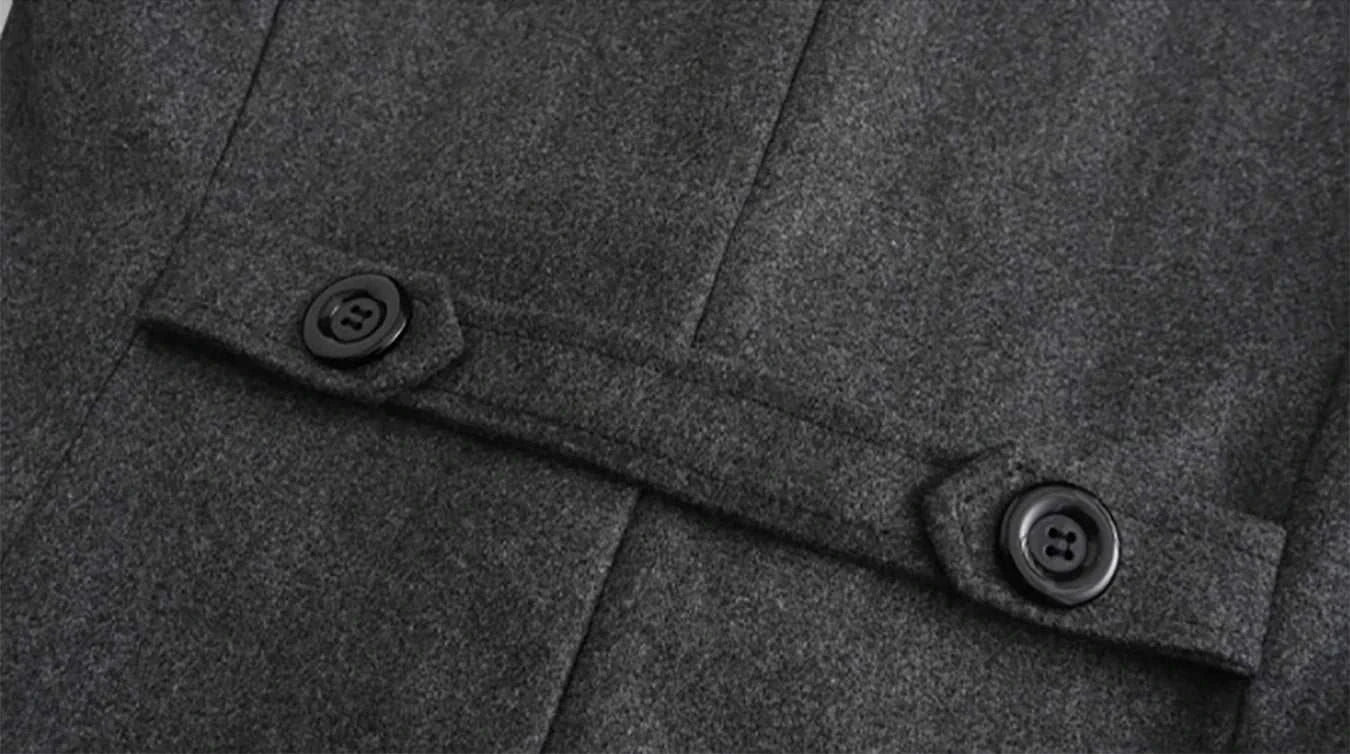 Close-up of buttoned strap detail on grey casual British long coat.