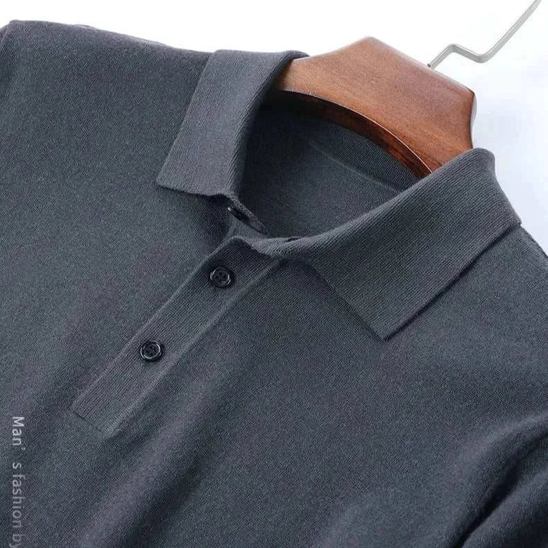 Antonios wool polo sweater in dark grey on a hanger.