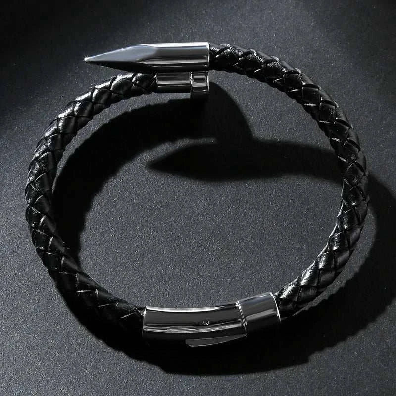 Nail leather men bracelet with stainless steel clasp on dark background.