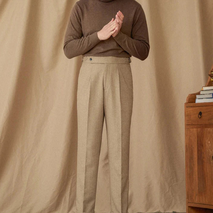 Wool winter Italian trousers in beige, worn by a standing man.