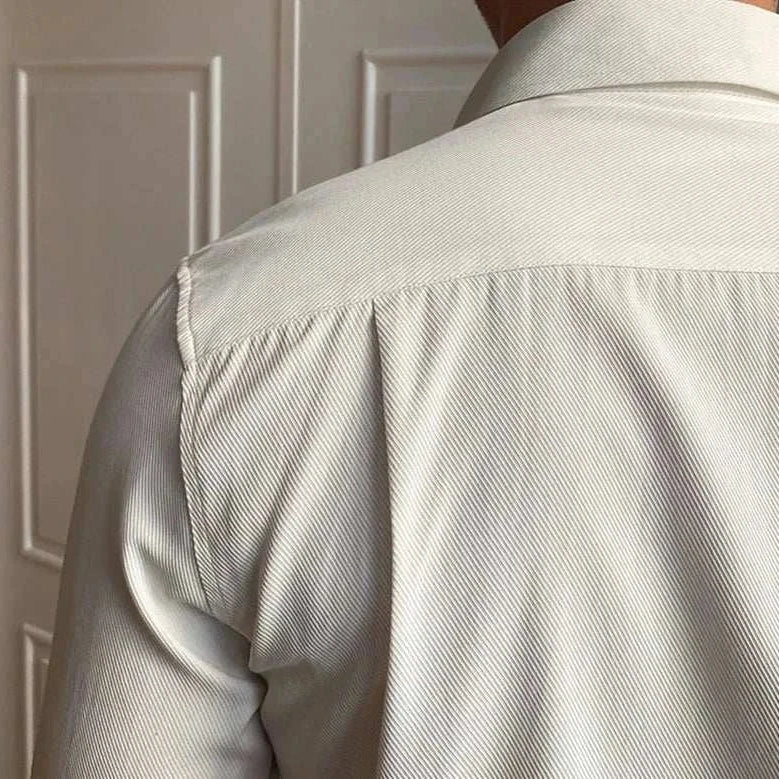 Back view of a men's business collar long sleeve shirt in solid light color.