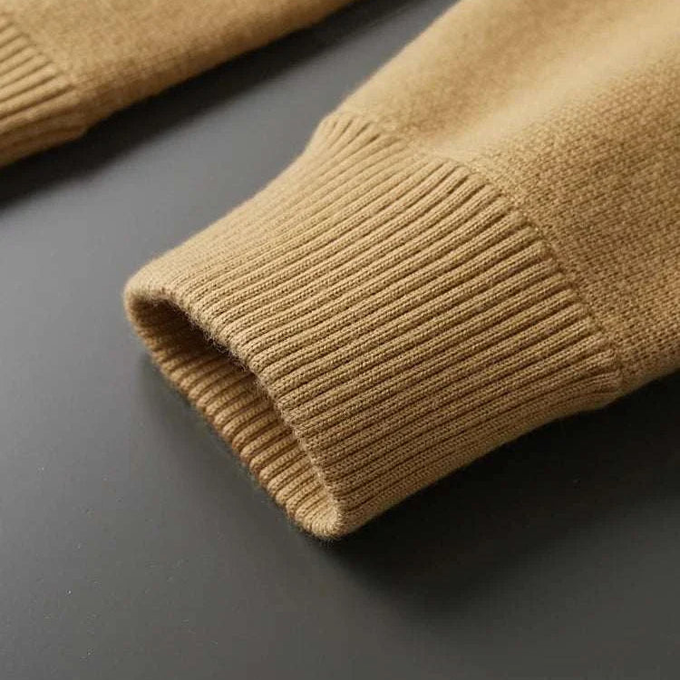 Antonios wool polo collar cardigan sleeve detail on black background.