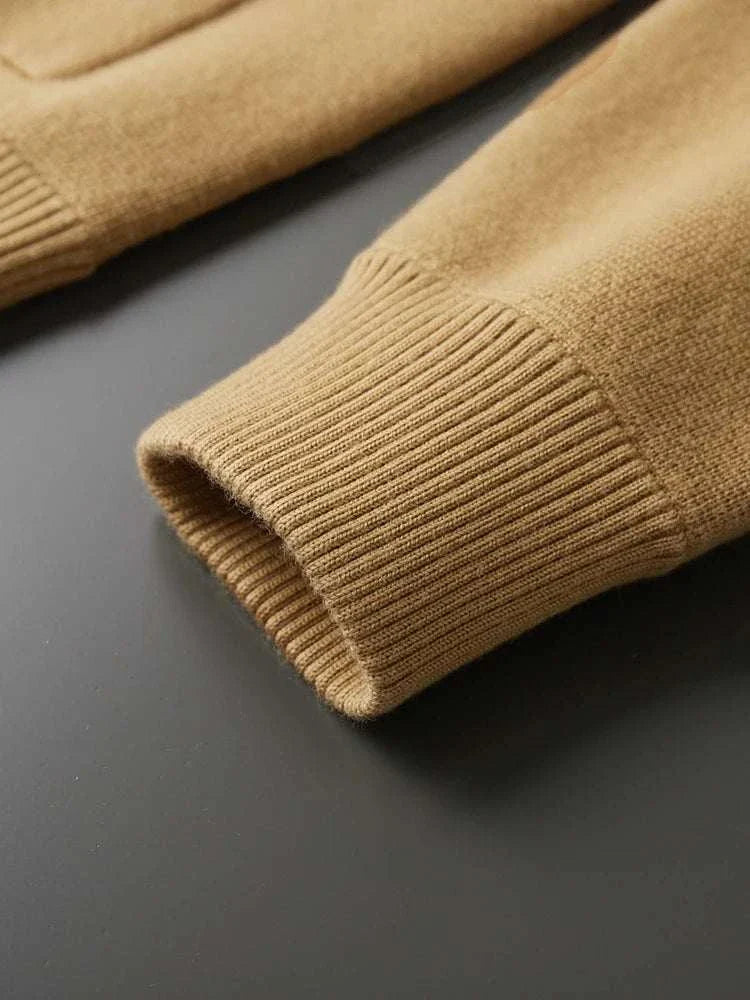 Antonios wool polo collar cardigan sleeve detail on black background.