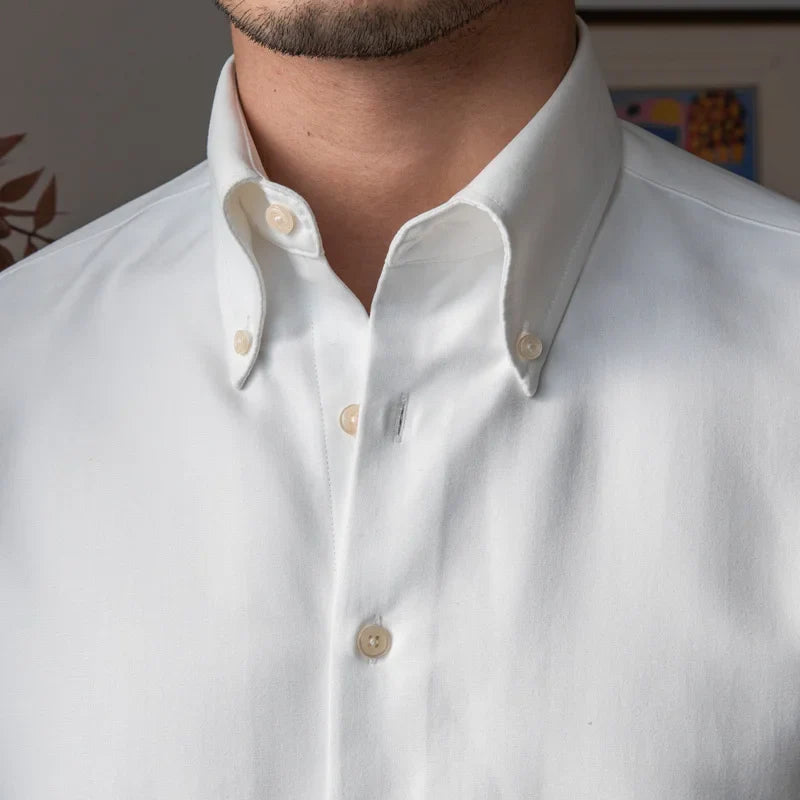 Slim fit solid business shirt with turn-down collar, suitable for office and social wear.